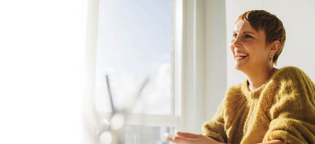 Smiling woman in yellow sweater 